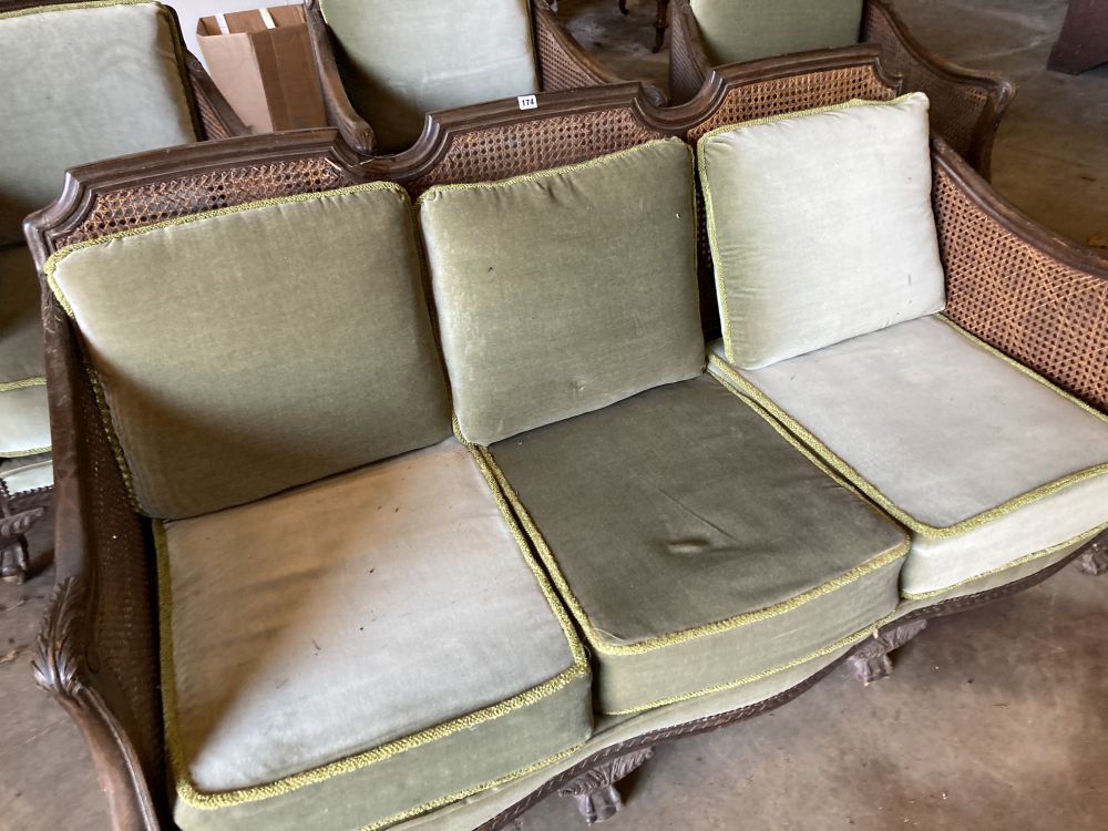 A 1920s carved beech four piece bergere suite
